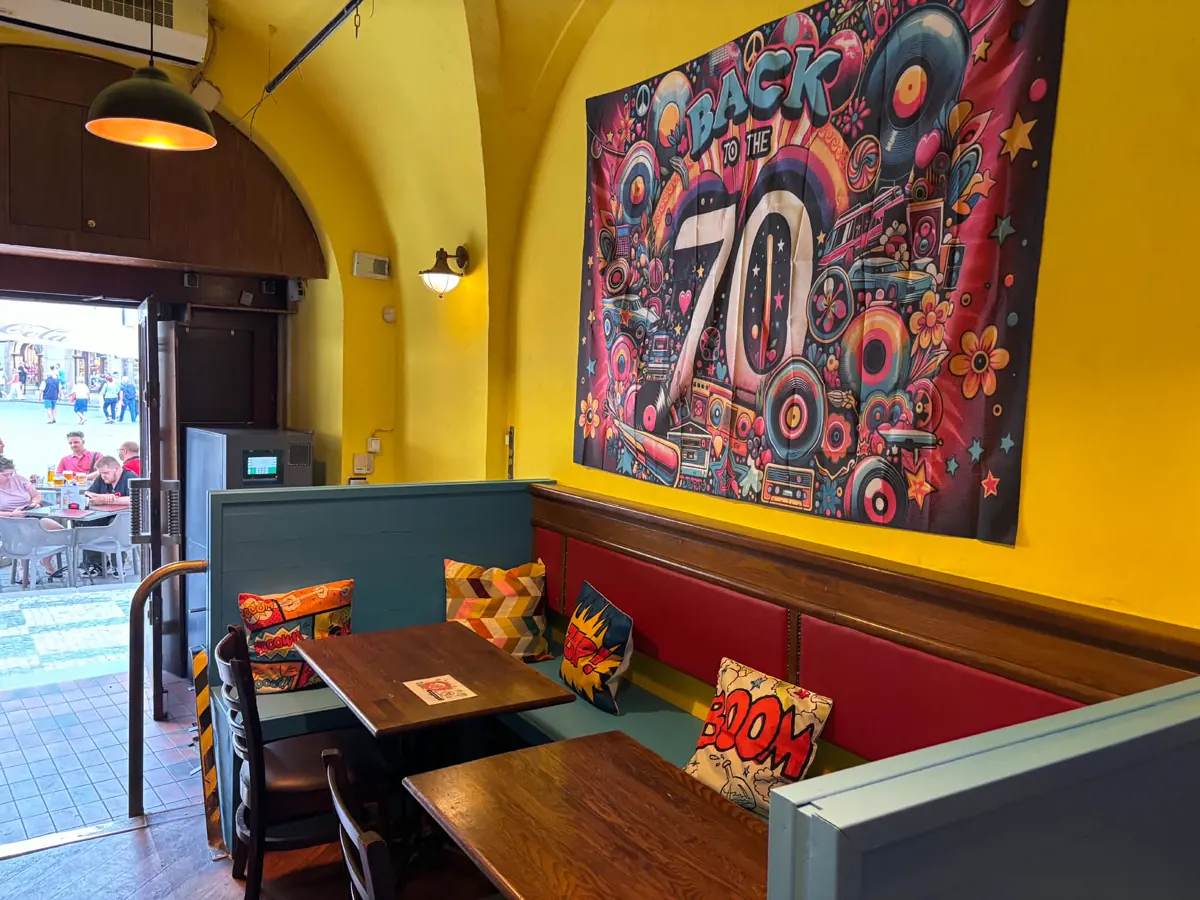 Booths under the Back to the 70s mural