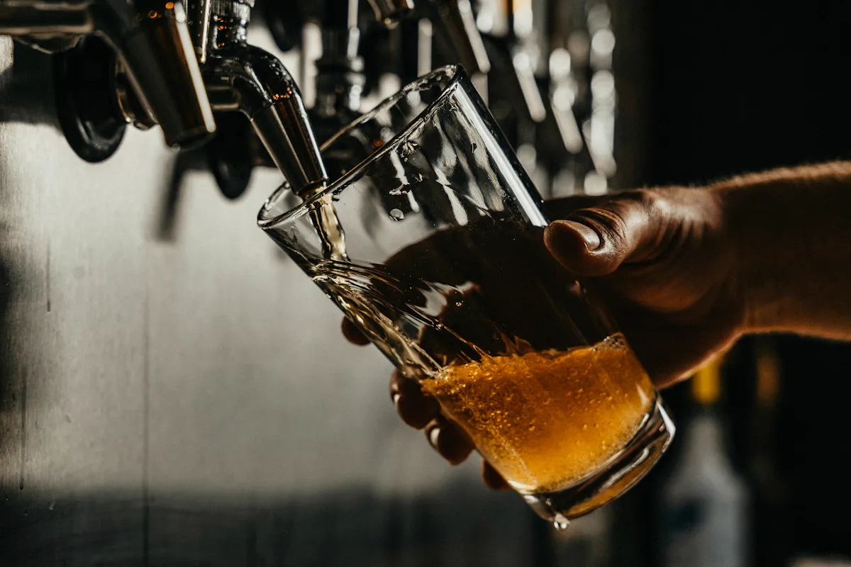 Beer being poured from the tap into a glass